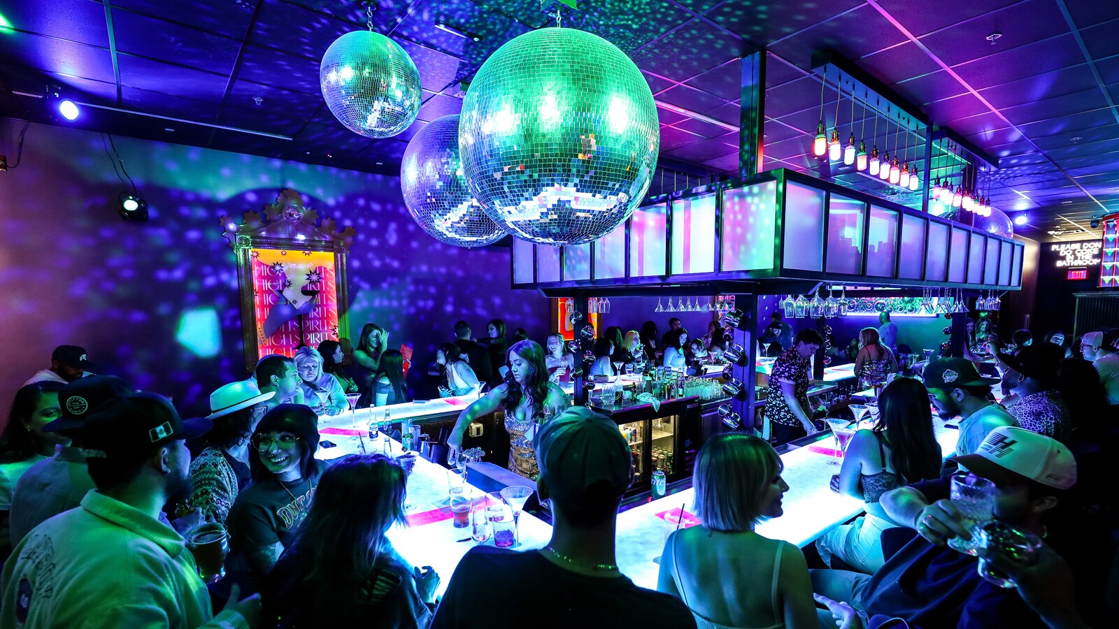Guests gathered beneath disco balls at Lola’s Liquors in Downtown Chandler